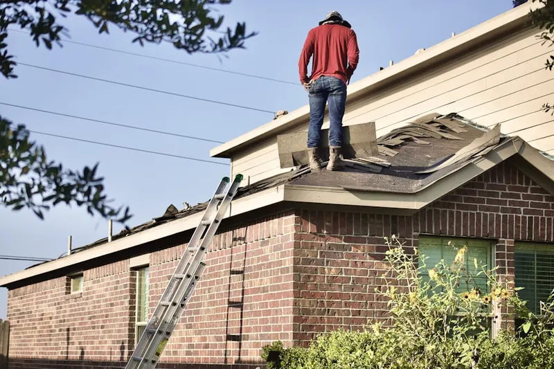 Professional roofer working on a residential roof in Banning